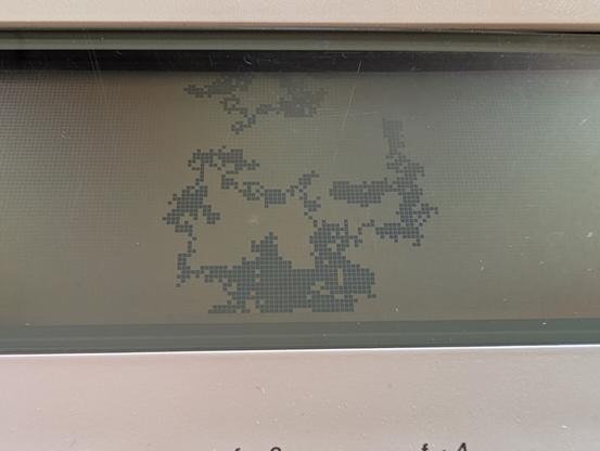 A close up of the LCD screen of my NEC PC-8201a showing a tangle of chunky pixels.