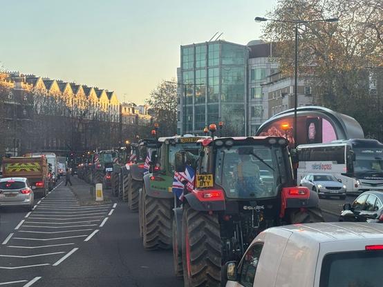 Tractors driving through busy London street during Budget Day protest