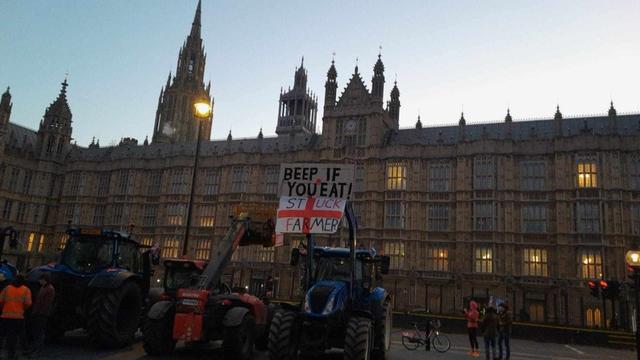 Tractors outside Westminster with “BEEP IF YOU EAT!” protest sign