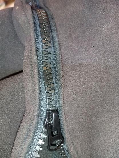 New black zipper sewn back into the jacket, not quite straight but good enough.