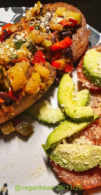 A plate of Goodstore 'Vegan Tender Steak',  Baked Sweet Potato topped with Stir Fried Vegetables, served with Fresh Avocado & Tomato. Topped w/ Yeast Flakes.