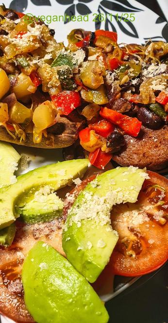 A plate of Goodstore 'Vegan Tender Steak',  Baked Sweet Potato topped with Stir Fried Vegetables, served with Fresh Avocado & Tomato. Topped w/ Yeast Flakes.