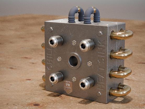Metallic cooling block with brass pipes on the side and flow connectors on the front. "Chill Heat Sink" on the front.