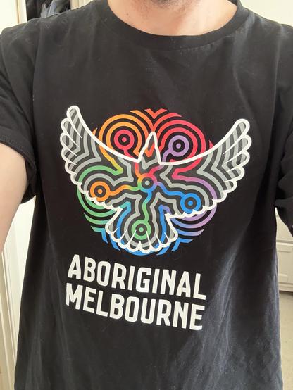 black t-shirt with colourful artwork featuring Bunjil the eagle, and the words “Aboriginal Melbourne”