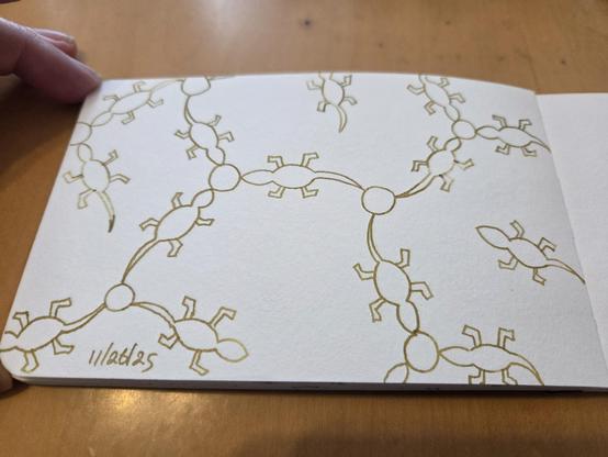Hand drawn generative/procedural art in ink on an open page of my sketchbook. The abstract pattern looks a bit like a chemistry diagram, but with lizard shapes instead of straight lines.