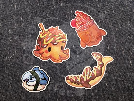 Stickers of a takoyaki octopus, mola taiyaki soft serve, chocolate banana shark, and a mola sushi