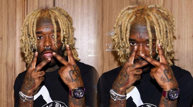 Side-by-side photos of Lil Uzi Vert posing with blond dreadlocks, facial piercings, and hand tattoos while holding up two fingers near their face against a wooden background.