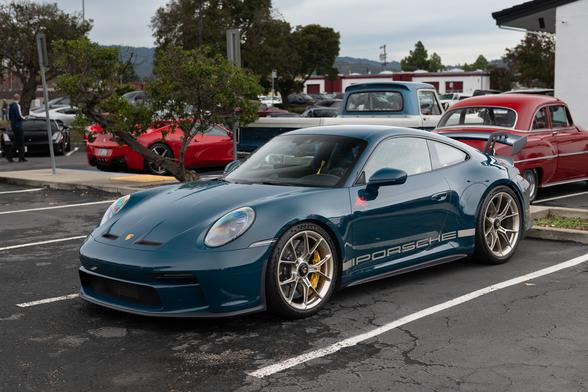 A dark teal sports coupe