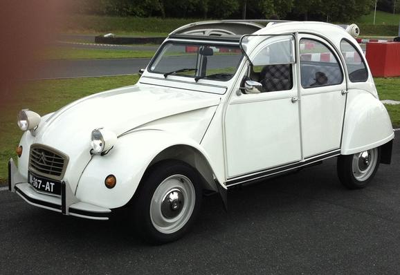 White Citroën 2CV with rolled back canvas sunroof, side view