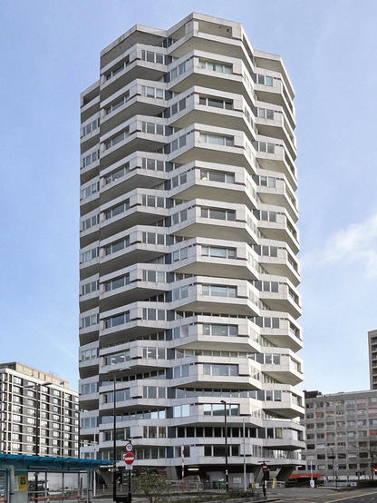 A black and white photograph of the NLA building in Croydon, with its distinctive rotated floor design