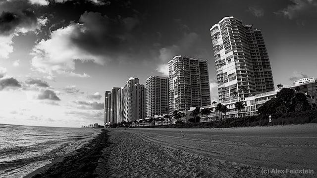 Beach,  sand, buildings and  sky with a fisheye in BW