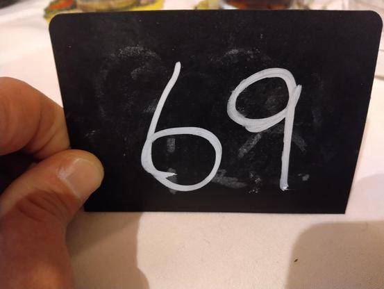 table sign with the number 69 (sixty nine) on it