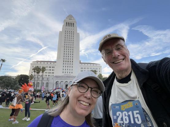 Me and the mister, pre-race, in front of Los Angeles City Hall. You can see a big orange inflatable turkey in the background.