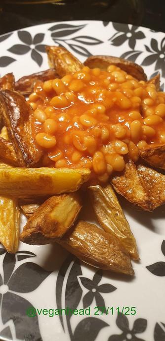 Hand cut homemade oven chips with baked beans.