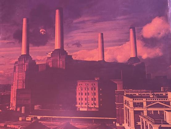 The gatefold for “Animals” by Pink Floyd, featuring Battersea Power Station and an inflatable pig floating between the smoke stacks.