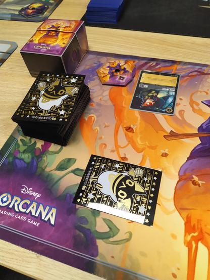 The first turn in a Lorcana game. One ink is exerted and a card with Nick Wilde is played upsidedown.