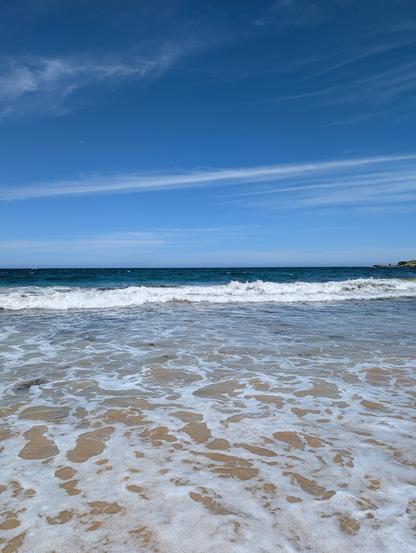 An eastern coast of New South Wales beach vista with whitecaps breaking on a pristine clean beach