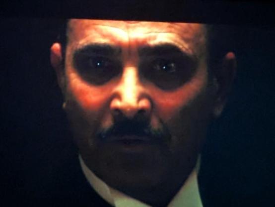 Opening scene of The Godfather - close up of a face lit from above in otherwise dark space