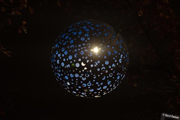 An illuminated blue globe shaped light shade.
