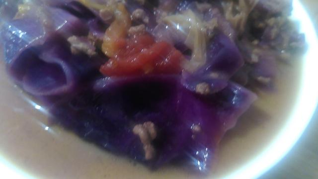 A plated portion if pink curry, which gets it's colour from the red cabbage.

The surface layer of the broth gets brownish due to tumeric in the oil.