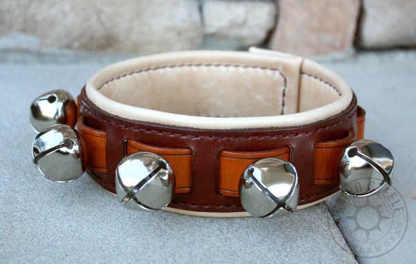 A light brown leather collar with silver bells