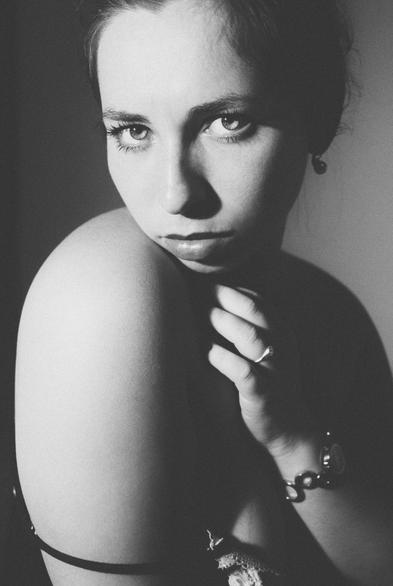 boudoir portrait of a young female german model, bare rounded shoulders adding old fashioned drama and curvature in a vintage style a la the famous works of Man Ray