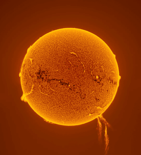 A solar prominence erupts from the Sun, reaching a distance over 500,000 km.