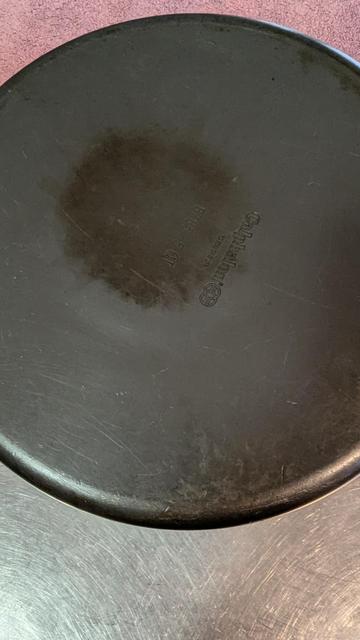 The bottom side of a Calphalon pot.