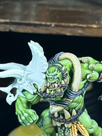 A close up of the same model’s face and jaw, with a horse jaw with tied teeth all over it.