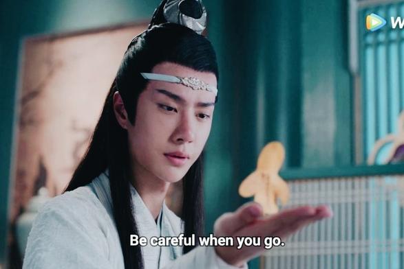 In a Koi Tower guest room, Lan Wangji holds his right hand level in front of him, looking down at the golden paperman standing upon it, and cautions/implores:

Be careful when you go.