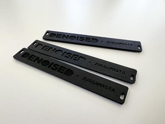 Black 3D printed Eurorack Panels with different types of surfaces.