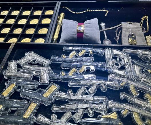 Bullion grade silver miniature g^ns, some with gold appliqué, all in custom plastic cases. Above to the left is a tray of gold coins.