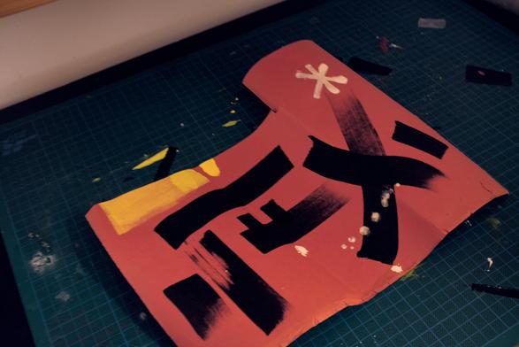 Another piece of paper, roughly cut out of something with black lines and a white star