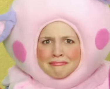 A woman in a bear costume, with a baffled/confused expression.