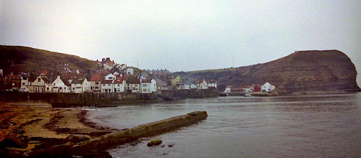 A fishing village, with a large promontory.