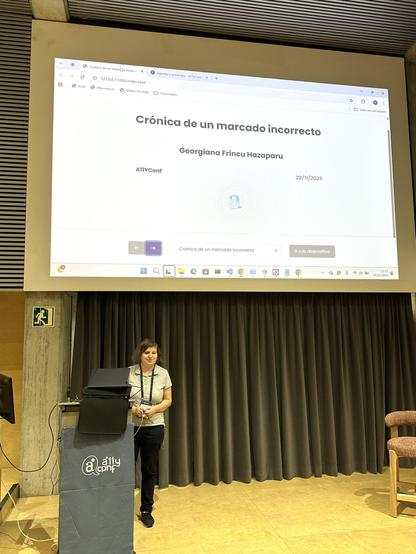 Georgiana Frincu en el escenario del auditorio de la a11yConf 2025 en Gerona hablando de marcaje para accesobilidad delante de la audiencia