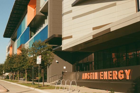 A brown and beige building with blue and orange accents, labeled AUSTIN ENERGY in orange letters.