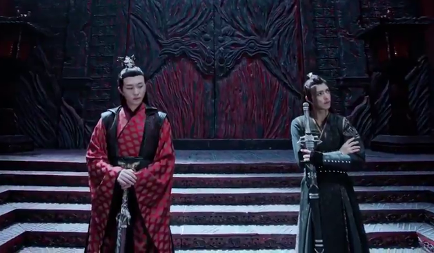 Wen Chao and Xue Yang stand in Wen Ruohan's a very pointed distance apart, both affecting an air of nonchalance. Wen Chao has the tip of his sword resting on the floor and both hands folded across the hilt and his head turned just enough to be able to see Xue Yang out of the corner of his eye. Xue Yang has his arms folded across his chest with his sword held in his left hand, weight shifted back more onto his right leg while his head is turned more to his left, away from Wen Chao.
