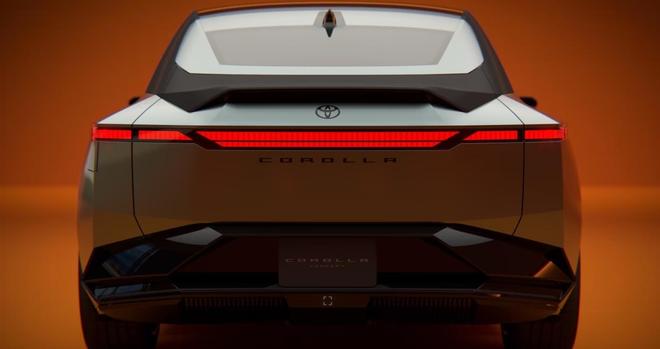 A rear view of a Toyota Corolla concept car, showcasing a sleek design with sharp lines and modern taillights against an orange background. The word "COROLLA" is prominently displayed.