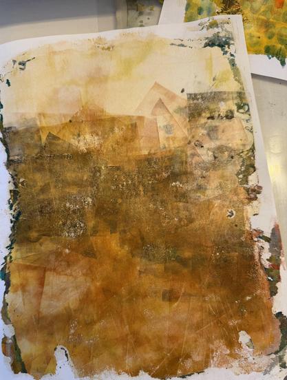 An abstracted print that is intended to be a blurred landscape. In colors of brown, gold, black.