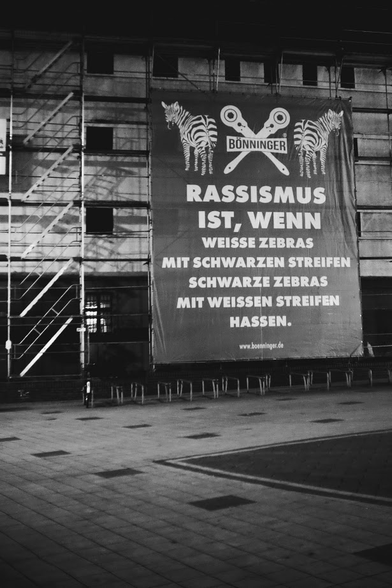 An anti-racist banner on scaffolding by the same firm that put the scaffold up. The interesting thing is that it is on the side of the building that used to be the Gestapo prison during the Nazi era.