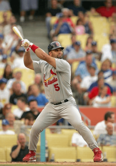 “Albert Pujols stretches out into his familiar batting stance—legs wide apart, bat quivering high above his shoulder, head up in an oddly proud way, like he’s a soldier sitting on a horse, like he’s posing for posterity.” — Joe Posnanski, 2009, describing Pujols’ stance at the height of his peak.