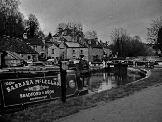 The canal basin at Bradford-Upon-Avon in Wiltshire. In the foreground is a narrow and on the background the lock gates which are closed.