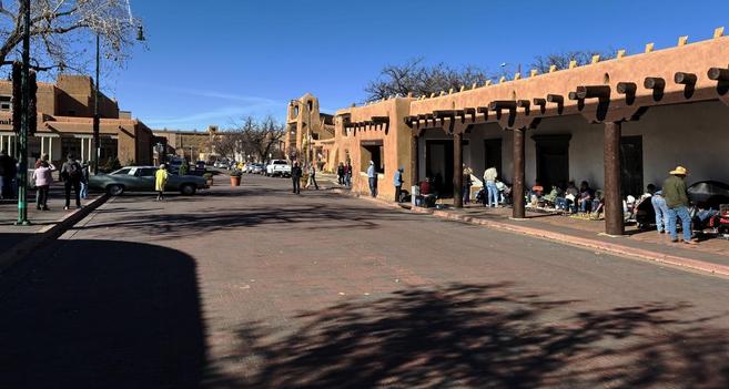 the plaza on a Saturday in November in Santa Fe, NM, showing the vendors selling native American jewelry and trinkets
