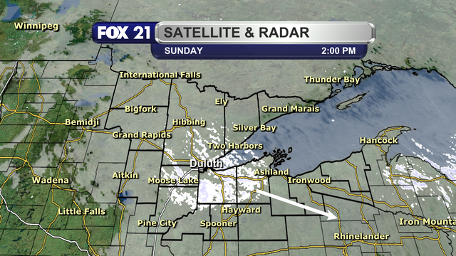 The satellite and radar over the Northland at 2 p.m. on November 30, 2025, shows a cluster of light snow showers passing over the heart of the region from northwest to southeast.  Cloud clover dominates the rest of the area with just a few peeks of sunshine poking through.