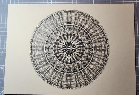 An intricate black and grey 3D-shaded mandala on cream paper under a bright light. It's styled like cathedral stonework architecture with bricks and columns and cracked stone.