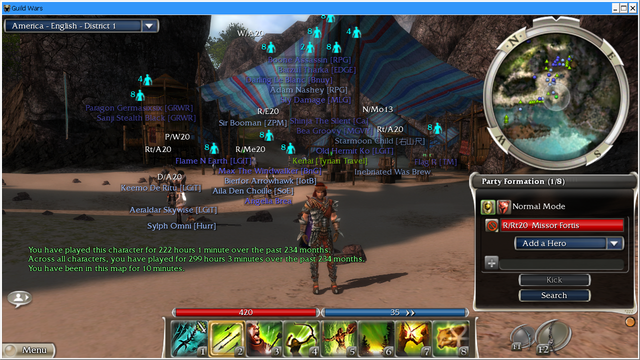 Screenshot of Guild Wars. A character is standing on a beach. In the background is a tent and some rock formations. The name tags of two dozen other players can be seen. 
The chat window is showing the following text in green: "You have played this character for 222 hours 1 minute over the past 234 months. Across all characters, you have played for 299 hours 3 minutes over the past 234 months. You have been in this map for 10 minutes."
(The user interface is enlarged for demonstration purposes)