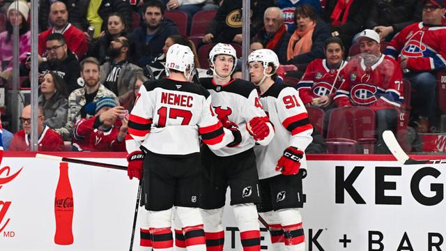 Simon Nemec and Luke Hughes celebrate a goal with New Jersey Devils teammate Dawson Mercer