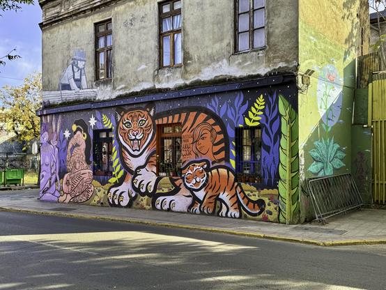 Photo of a historic building with a cat-themed mural
