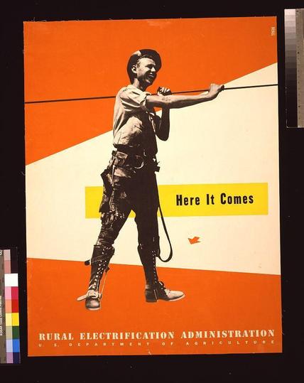 The image depicts a vintage poster for the Rural Electrification Administration, which is part of the U.S. Department of Agriculture. The main subject is an individual dressed as a lineman, wearing work boots and suspenders with pockets filled with tools or equipment relevant to their profession. They are gripping a wire against a bright orange backdrop on one side transitioning into cream-colored space at another edge. Above them, text reads "Here It Comes," while below the figure it states "RURAL ELECTRIFICATION ADMINISTRATION U.S. DEPARTMENT OF AGRICULTURE." The poster's bold use of colors and striking imagery is designed to draw attention and convey a sense of progress or development in rural electrification efforts during that period.